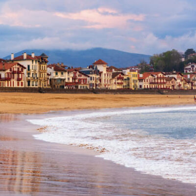 Traditional basque timber houses facing sand beach in Saint Jean de Luz, a resort town on Atlantic coast, Bay of Biscay, France